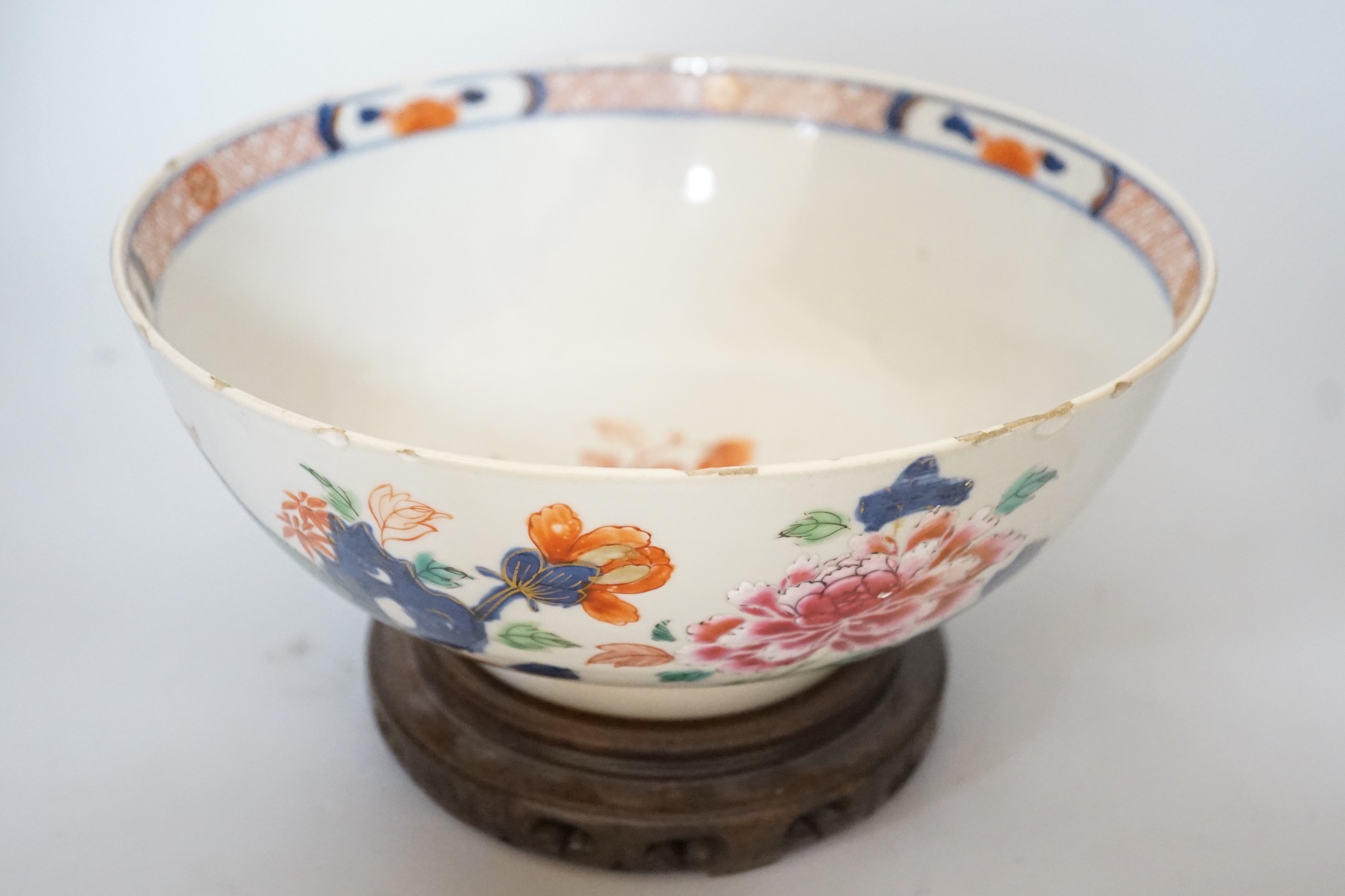 An 18th century Chinese famille rose bowl on wood stand, c.1740, diameter 26cm